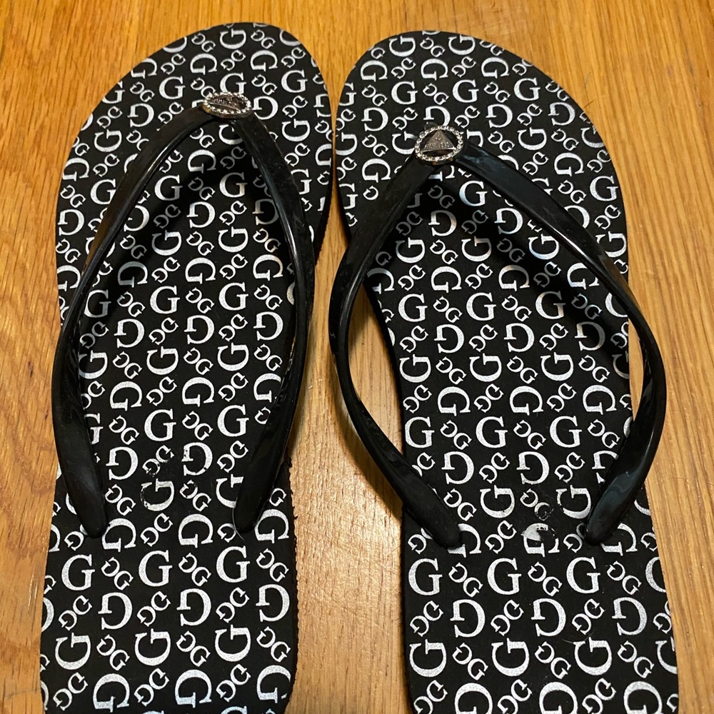 Black and white guess flip flops